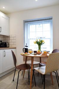 a kitchen with a table and chairs and a window at The Old Captains Lookout in Falmouth