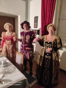 two women in costumes standing in a room at Residence Via Benamati in Cagli