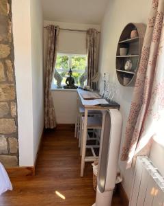 a small kitchen with a table and a window at Stunning location on Pendle Hill in Nelson