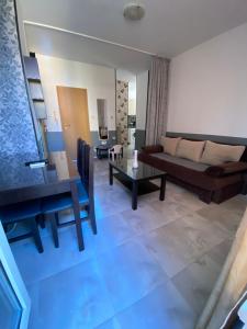 a living room with a couch and a table at Dadi Oazis Ravda in Ravda