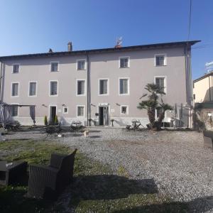 a large white building with a dog in front of it at B&B Principe Calaf 3 in Lucca