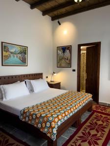a bedroom with a large bed in a room at Hotel Mangalemi in Berat
