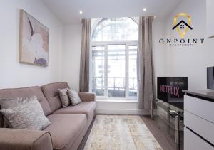 a living room with a couch and a window at ✰OnPoint - Fantastic 1 Bedroom Apt with PARKING✰ in Reading