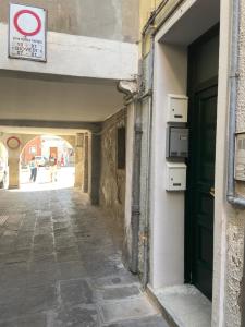 un vicolo in un vecchio edificio con porta verde di CASA BRUNA a Chioggia