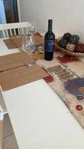 a bottle of wine and a glass on a table at Altos San Martín in Concepción del Uruguay