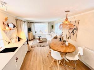 a kitchen and dining room with a table and chairs at Trendy House Hattem nr64 in Hattemerbroek