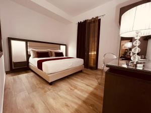 a bedroom with a bed and a dresser in it at Suite SWEET DREAMS Dan champs in San Vito lo Capo