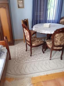 a dining room with a table and two chairs at Studio apartman jelena in Zaovine