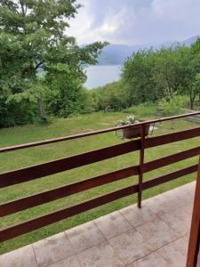 a wooden fence with a view of the water at Studio apartman jelena in Zaovine