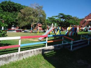 a playground with a slide in a park at Maravilha e Sossego Enseada Azul-Guarapari WI-FI rápido 350mbs in Guarapari