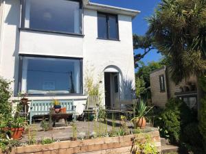 a house with a large window on the front of it at Sunnyview 5-Bed House in Kingsbridge with parking in Kingsbridge