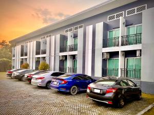 a row of cars parked in front of a building at B3 Hotel in Nakhon Si Thammarat