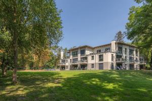 a large building with a lawn in front of it at Ferienwohnungen am Wasser - Krakow am See in Krakow am See