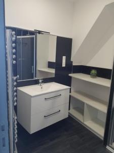 Un baño blanco con lavabo y espejo. en Le Plaisance, en Ourville-en-Caux 9 fotos más