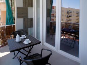 a small table and chairs on a balcony with a view at ATOCHA MUSEOS in Madrid