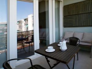 a table and chairs on a balcony with a view of a building at ATOCHA MUSEOS in Madrid