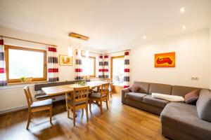 a living room with a couch and a table at Haus Schwarzenberg in Stummerberg