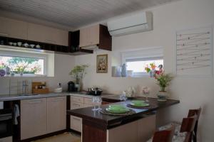 a kitchen with a table with glasses on it at Apartamentai Šilutėje in Šilutė