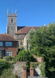 an old church with a clock tower on top of it at Stunning 1 bedroom self contained apartment in Kent