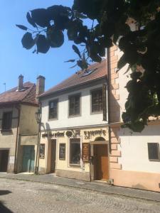 a white building on the side of a street at Penzion U Borovičků in Litoměřice