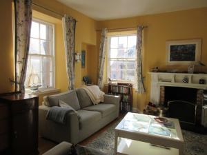 a living room with a couch and a fireplace at Anchor House in Pittenweem