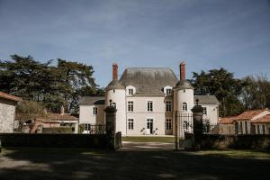 a large white house with a black roof at Domaine de La Mazure in La Chapelle-Basse-Mer