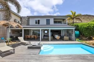 a house with a swimming pool in front of a house at LIFE IS GOOD IN CUL DE SAC in Saint Martin