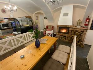 a living room with a wooden table and a fireplace at HAMR Apartmány in Nové Hamry