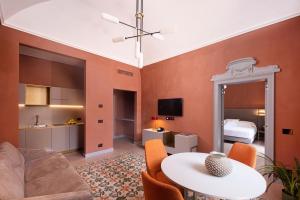 a living room with a couch and a table at VIS Urban Suites&Spa in Bari