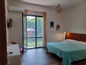 a bedroom with a bed and a large window at Anthea in Reggio Calabria