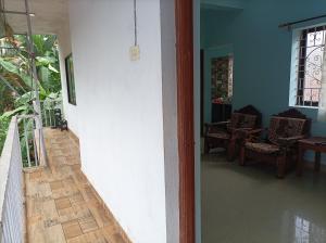 a hallway of a house with a staircase and a room at Hakuna Matata Holiday Homes Goa Entire Apartment 1BHK in Baga
