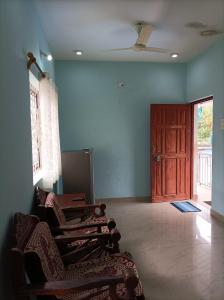 a living room with two chairs and a door at Hakuna Matata Holiday Homes Goa Entire Apartment 1BHK in Baga