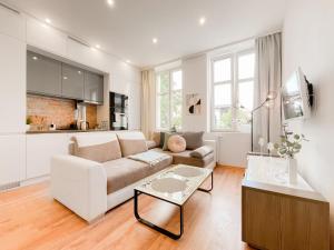 a living room with a couch and a table at COCO Apartments Gdańsk Centrum Górka in Gdańsk