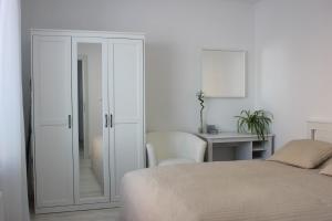 a bedroom with a bed and a desk and a table at LEO Apartment FREE PARKING!!! in Bratislava