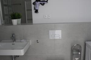 a bathroom with a white sink and a mirror at LEO Apartment FREE PARKING!!! in Bratislava +15 photos