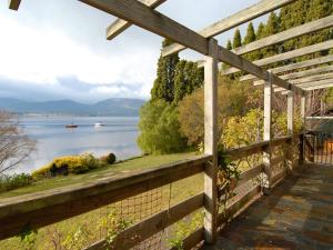 a wooden fence with a view of the water at Derwent Vista in Austins Ferry
