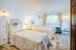 a bedroom with two beds and a window at Casa Cupula in Poço Partido +15 photos