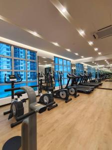 a gym with a row of treadmills and machines at 1601 SKS MidValley Terminal bus NetflixWifi By STAY in Johor Bahru