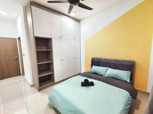 a bedroom with a bed with a ceiling fan at 1601 SKS MidValley Terminal bus NetflixWifi By STAY in Johor Bahru