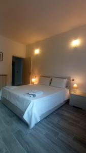 - une chambre avec un grand lit blanc et deux lampes dans l'établissement Mirdita - Casa Vacanze, à La Spezia
