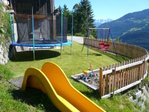a playground with a slide and a swing set at Haus Schwarzenberg in Stummerberg