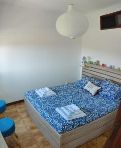 a bedroom with a bed with two towels on it at Ocean View Dive House in Sesimbra