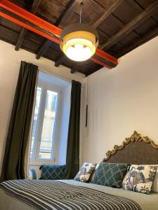 a bedroom with a bed with a lamp and a window at Casa Leoncino B&B in Rome