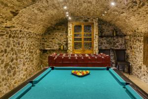 a pool table with a bowl of fruit on it at Mas Renart in Mollet de Perelada