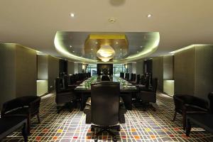 a long dining room with a long table and chairs at Ming Garden Hotel in Kota Kinabalu