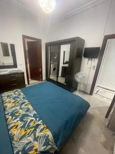 a bedroom with a bed and a dresser and a mirror at Appartemet haut standing in Tunis
