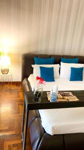 a room with two beds with blue and white pillows at Suite room in Aversa