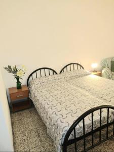 a bedroom with a bed and a vase of flowers on a table at CINQUE TERRE HOUSE OF THE PORT with PARKING in La Spezia