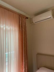 a bedroom with a bed and a window with a heater at Coastal, 2-bedroom rental unit in Golem +4 photos