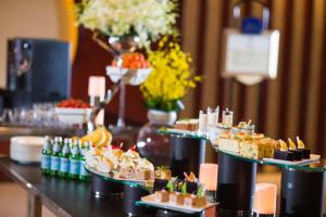 a table with several plates of desserts and drinks at Yiwu Ocean Hotel - Original Best Western Premier Ocean Hotel in Yiwu